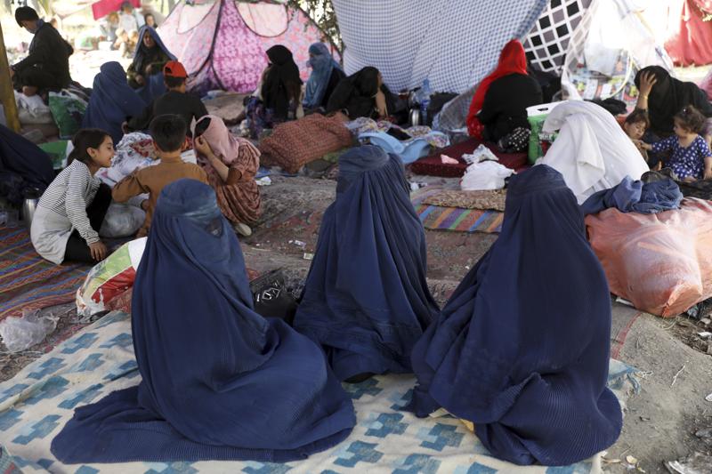 Internally displaced Afghans from northern provinces, who fled their home due to fighting between the Taliban and Afghan security personnel, take refuge in a public park Kabul, Afghanistan, Friday, Aug. 13, 2021. The Taliban have completed their sweep of the country's south on Friday, as they took four more provincial capitals in a lightning offensive that is gradually encircling Kabul, just weeks before the U.S. is set to officially end its two-decade war. (AP Photo/Rahmat Gul)