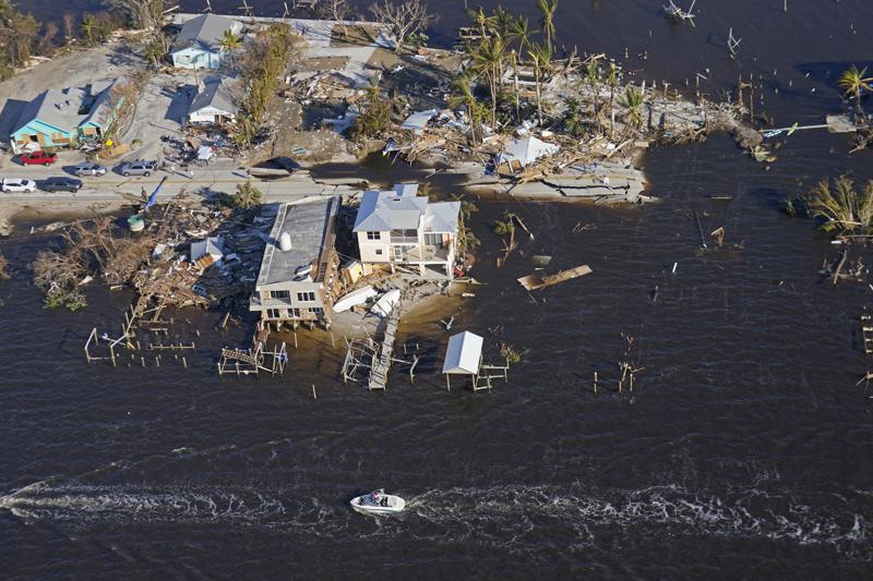 FILE - The bridge leading from Fort Myers to Pine Island, Fla., is seen heavily damaged in the aftermath of Hurricane Ian on Pine Island, Fla., Oct. 1, 2022. On Friday, Dec. 9, Florida lawmakers released a massive property insurance bill that would create a $1 billion reinsurance fund, seek to reduce insurance lawsuits and force more people out of the state-created insurer of last resort even if it means property owners end up paying more. The bill was filed less than three days before lawmakers begin a special session on insurance, property tax relief for Hurricane Ian victims and reducing tolls for frequent commuters. (AP Photo/Gerald Herbert, File)