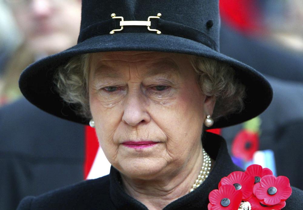 FILE - In this Thursday, Nov. 7, 2002 file photo, Britain's Queen Elizabeth II sheds a tear during the Field of Remembrance Service at Westminster Abbey, London.Queen Elizabeth II, Britain’s longest-reigning monarch and a rock of stability across much of a turbulent century, has died. She was 96. Buckingham Palace made the announcement in a statement on Thursday Sept. 8, 2022. (Jeremy Selwyn/Pool Photo via AP, File)