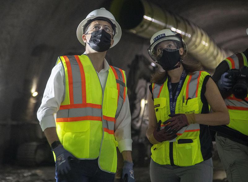 Construction project manager Gabrielle Ferro, second right, speaks with U.S. Secretary of Transportation Pete Buttigieg, during a tour of an underground tunnel for the expansion of the Hartsfield–Jackson Atlanta International Airport plane train tunnel at the Hartsfield–Jackson Atlanta International Airport, Friday, May 21, 2021, in Atlanta. (Alyssa Pointer/Atlanta Journal-Constitution via AP)