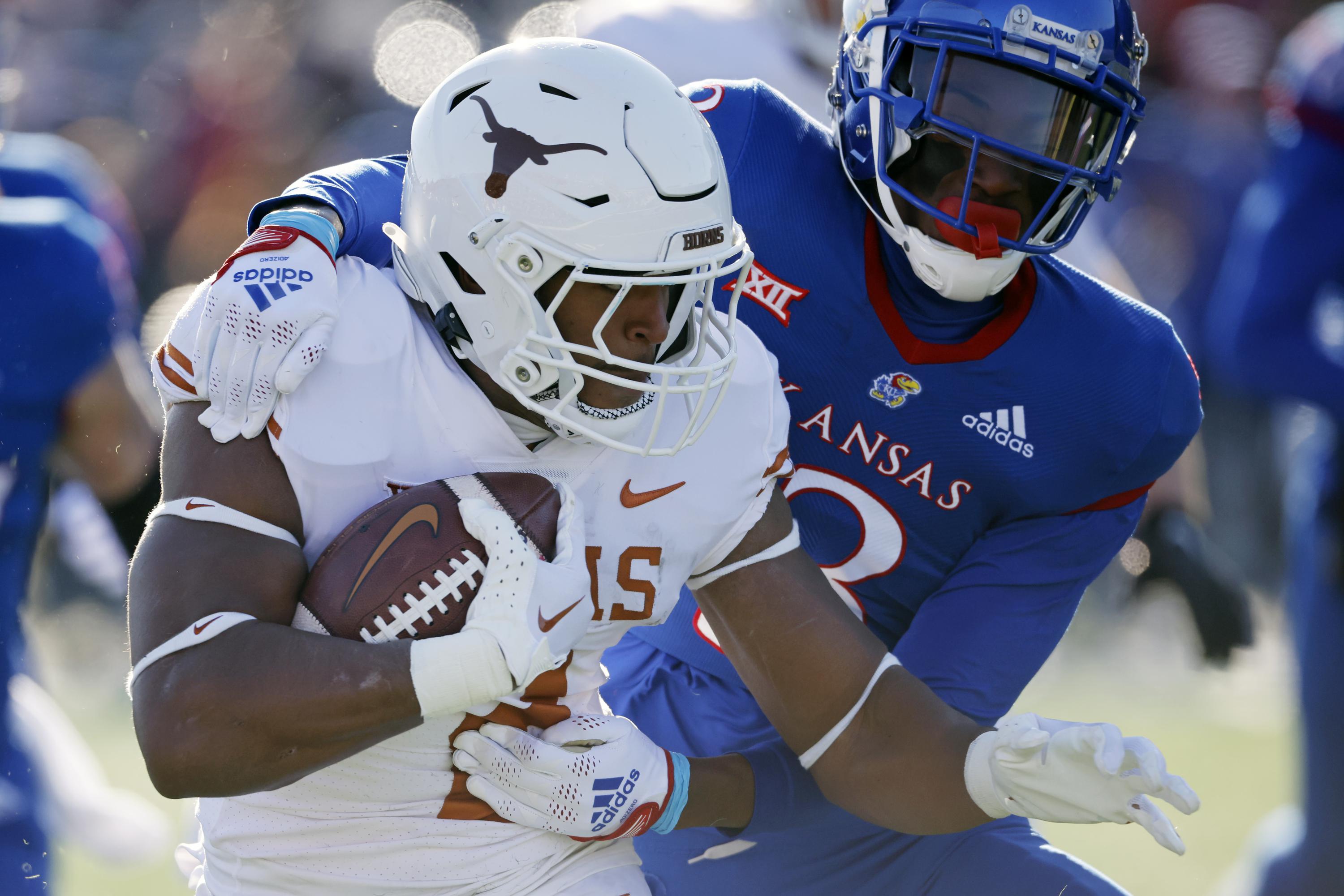 Robinson runs for 243 yards, 4 TDs as Texas routs KU 5514 AP News