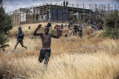 Migrantes emprenden la carrera en suelo español después de cruzar las vallas que separan el enclave español de Melilla, del territorio de Maruecos, el viernes 24 de junio de 2022. (AP Photo/Javier Bernardo)