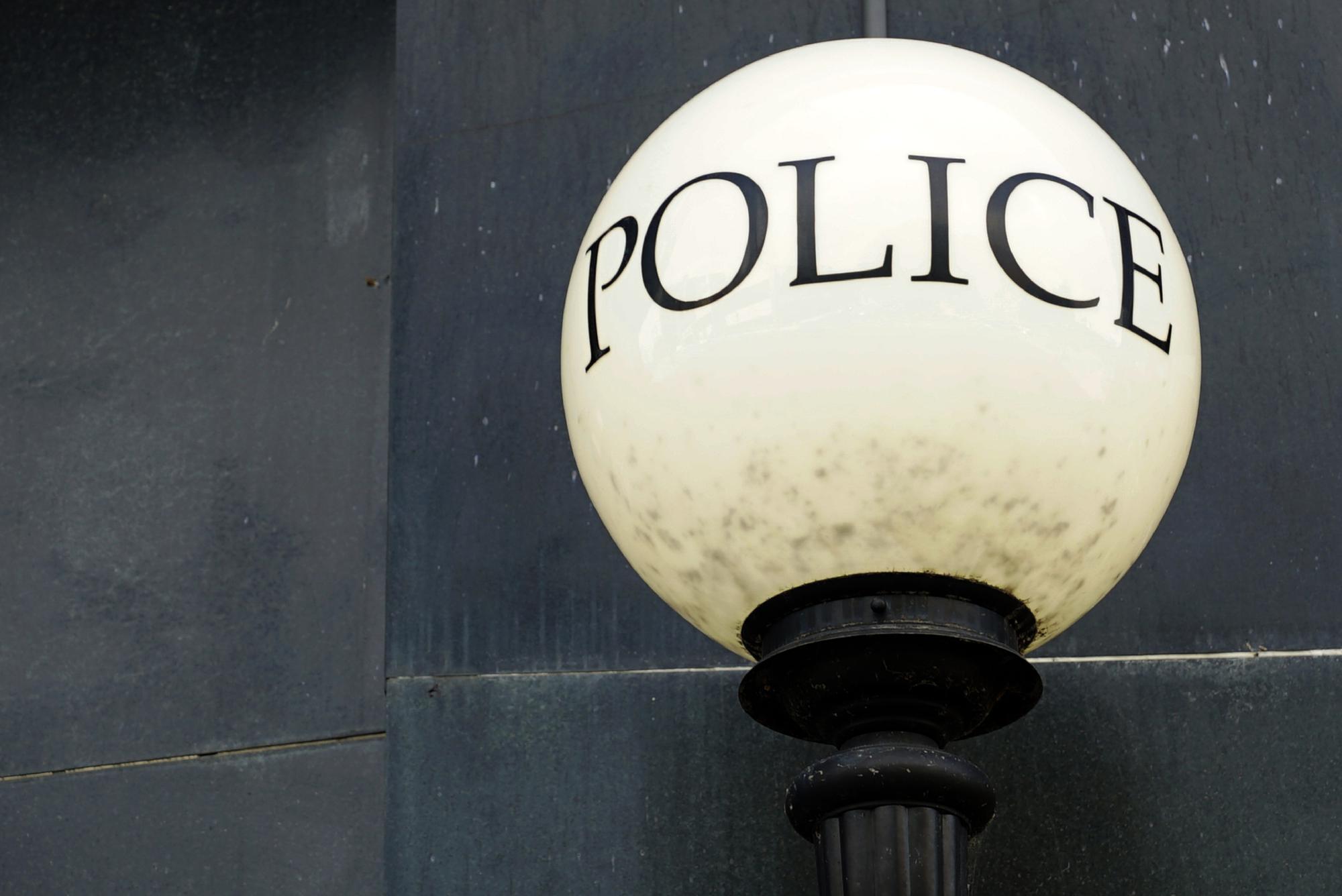 A lamp shines outside police headquarters in Greensboro, N.C.