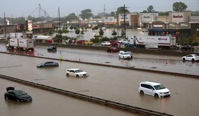 Abandoned cars are scattered by flooding across a shuttered Interstate 70 at Mid Rivers Mall Drive in St. Peters after heavy rain fell through the night and into the morning on Tuesday, July 26, 2022. (Robert Cohen/St. Louis Post-Dispatch via AP)