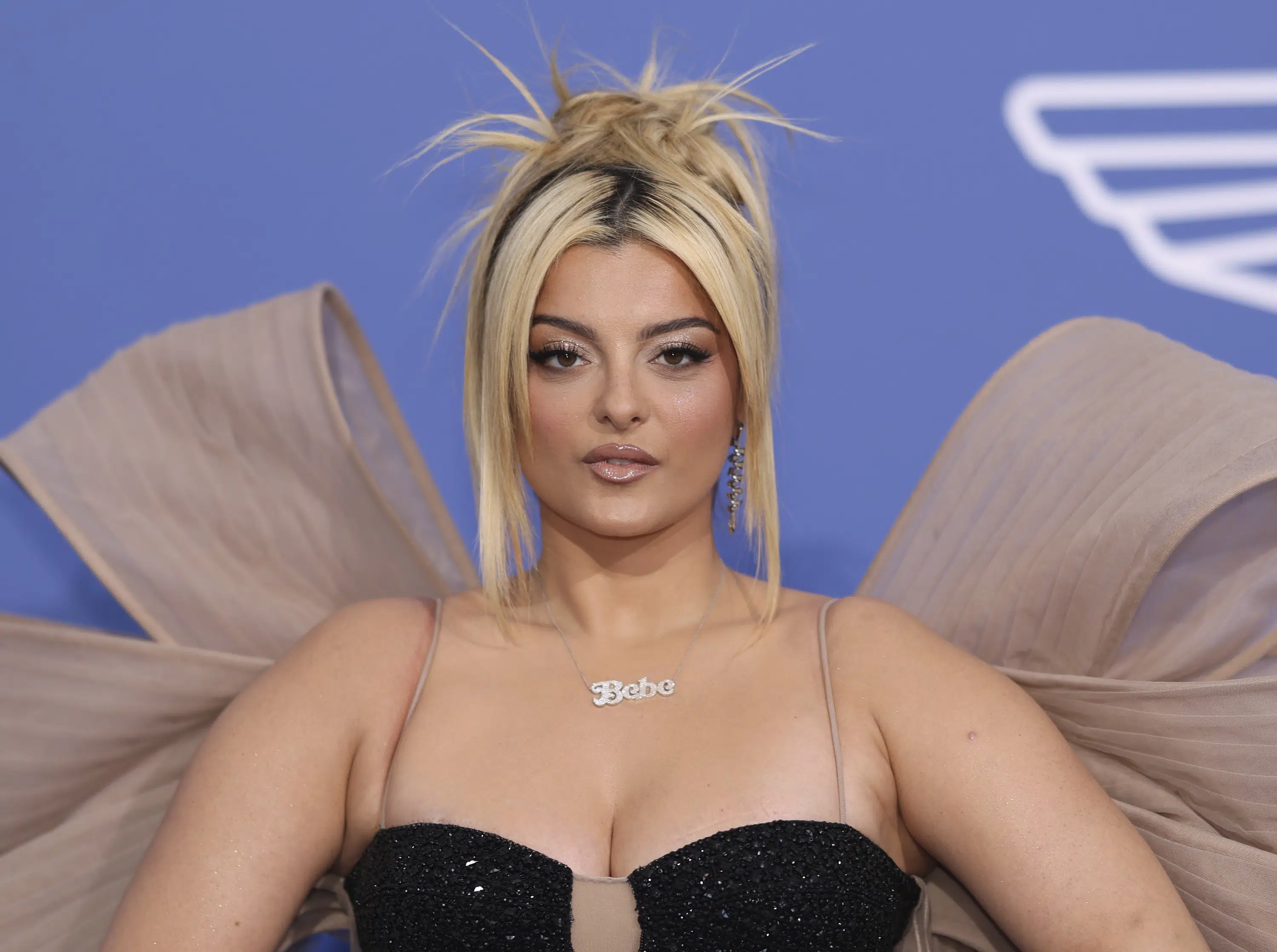 Singer Bebe Rexha says she’s okay after being hit in the face on stage by throwing a phone