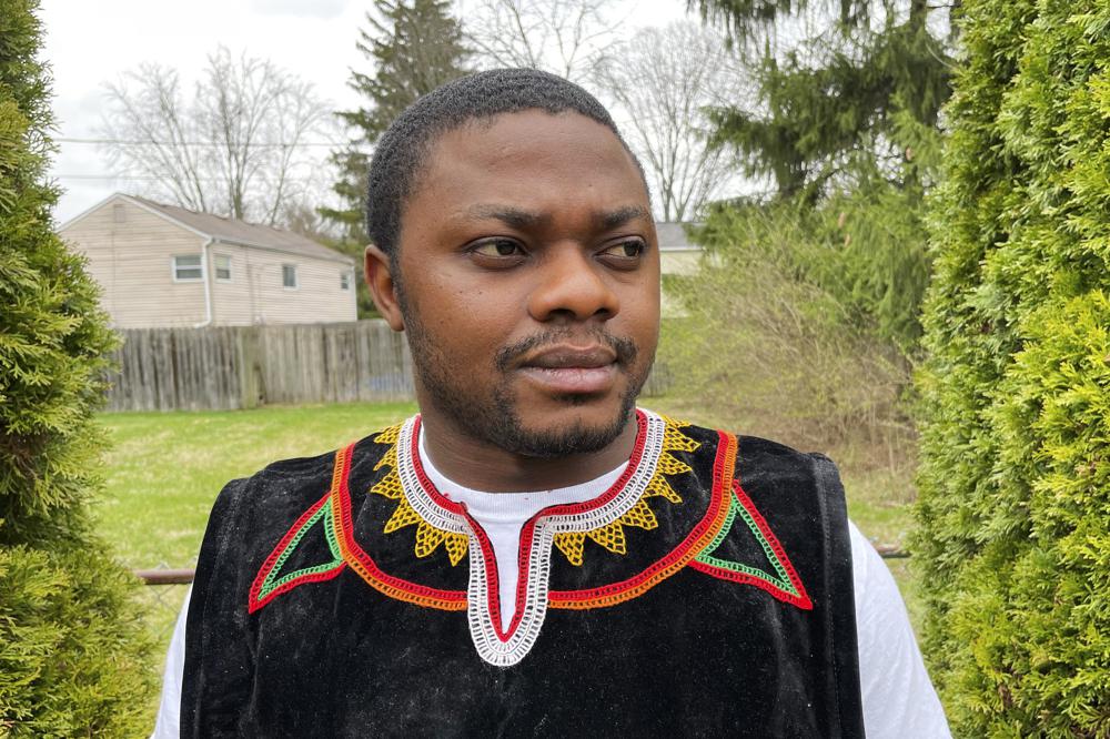 Wilfred Tebah, who fled Cameroon during its ongoing conflict, poses for a photo in the backyard of his home, Thursday, March 31, 2022, in Columbus, Ohio. African refugees say the recent decision to grant Ukrainians fleeing war refugee status and other humanitarian protections underscores the racial bias inherent in American immigration policy. Tebah says he and other immigrants from Cameroon have long been deserving of similar humanitarian considerations. (AP Photo/Patrick Orsagos)