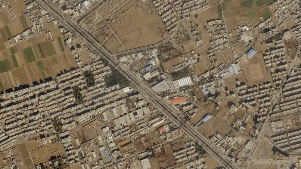 This satellite image from Planet Labs PBC shows damage on the roof of an Iranian military workshop, center, after a drone attack in Isfahan, Iran, Thursday, Feb. 2, 2023. Satellite photos analyzed by The Associated Press on Friday showed damage done to what Iran describes as a military workshop attacked by Israeli drones, the latest such assault amid a shadow war between the two countries. (Planet Labs PBC via AP)