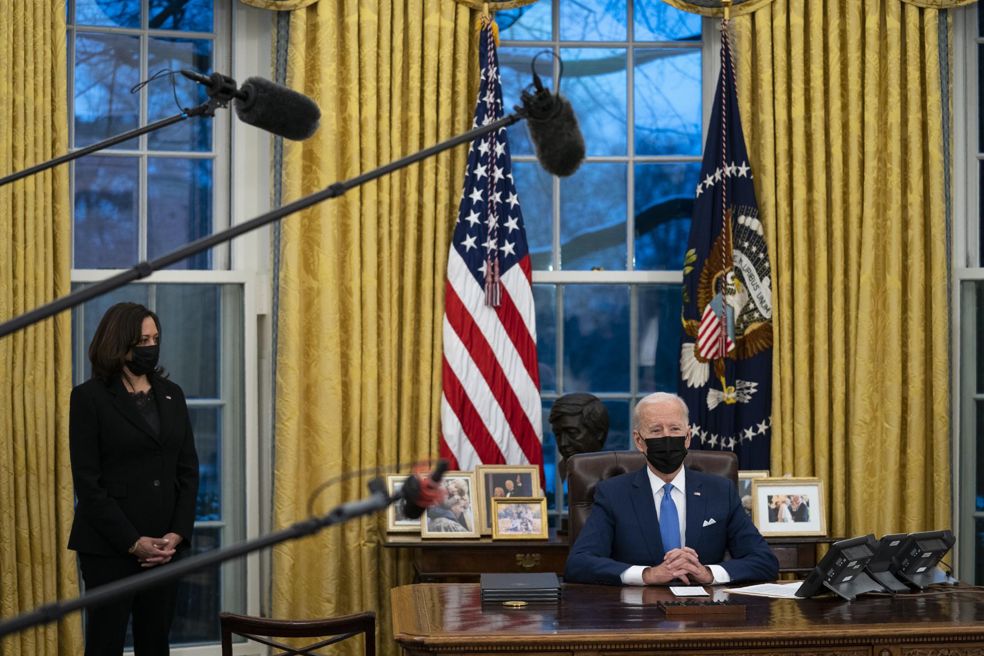 FILE - Vice President Kamala Harris, left, listens as President Joe Biden delivers remarks on immigration, in the Oval Office of the White House in Washington on Feb. 2, 2021. Biden took office on Jan. 20 and almost immediately, numbers of migrants exceeded expectations. (AP Photo/Evan Vucci, File)