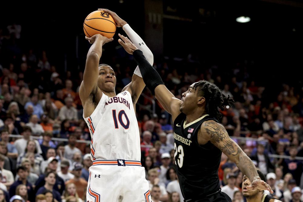 FILE - Auburn forward Jabari Smith (10) shoots a 3-pointer over Vanderbilt guard Jamaine Mann (23) during the second half of an NCAA college basketball game Feb. 16, 2022, in Auburn, Ala. Smith is one of the top forwards in the upcoming NBA draft. (AP Photo/Butch Dill, File)