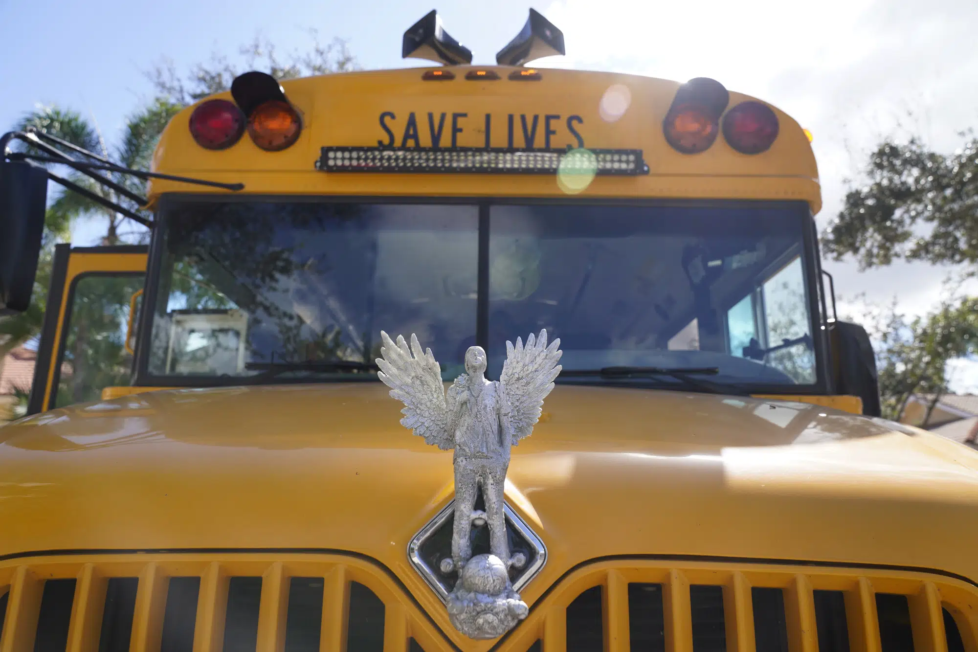 A hood ornament sculptured by Manuel Oliver of his son Joaquin with angel wings on a bus that the family takes around the country, is shown, Monday, Jan. 30, 2023, at the Oliver home in Coral Springs, Fla. The Oliver's 17-year-old son Joaquin was killed at Parkland's Marjory Stoneman Douglas High School shooting five years ago. Manuel and his wife Patricia Oliver started a foundation, Change the Ref, to challenge the political influence of the National Rifle Association and gun manufacturers. (AP Photo/Wilfredo Lee)