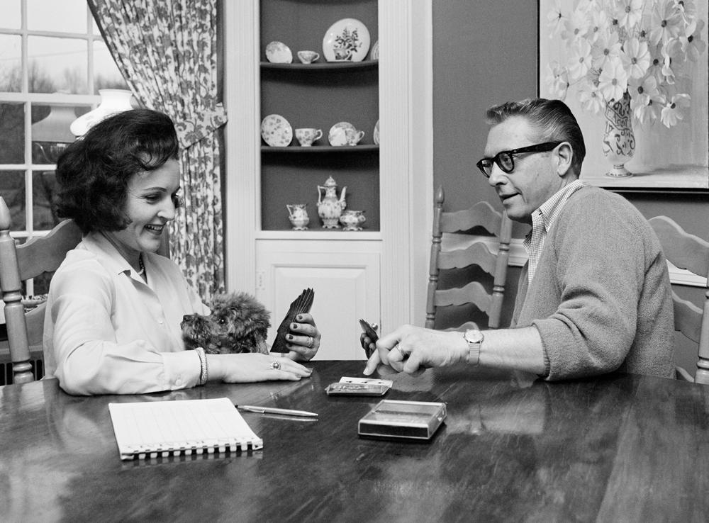 FILE - Allen Ludden and his wife Betty White plays a game of cards in their home in Westchester, N.Y. on April 29, 1965. Betty White, whose saucy, up-for-anything charm made her a television mainstay for more than 60 years, has died. She was 99.   (AP Photo/Bob Wands, File)