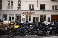 FILE - Uncollected garbage is piled up on a street in Paris, March 15, 2023, during an ongoing strike by sanitation workers. (AP Photo/Thomas Padilla, File)