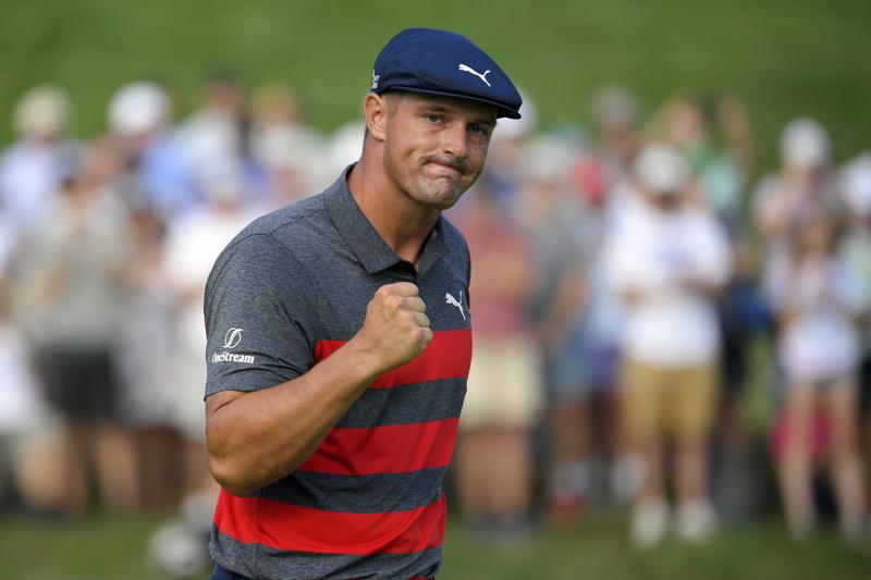 FILE- In this Aug. 29, 2021, file photo, Bryson DeChambeau reacts after sinking his putt on the 16th green during the final round of the BMW Championship golf tournament at Caves Valley Golf Club in Owings Mills, Md. When DeChambeau arrives at Whistling Straits for the Ryder Cup the 6-foot-1, 235-pound disrupter with a world-leading driving average of 323.7 yards, will bring with him an epic amount of baggage. He is in the middle of a months-long feud with one of his teammates, Brooks Koepka, who happens to have three more major titles than DeChambeau.  (AP Photo/Nick Wass, File)