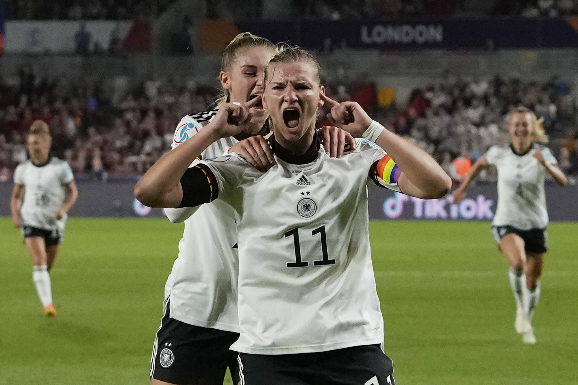 FILE - Germany's Alexandra Popp celebrates with Jule Brand, centre left, after scoring her side's second goal during the Women Euro 2022 quarter final soccer match between Germany and Austria at Brentford Community Stadium in London, Thursday, July 21, 2022. (AP Photo/Alessandra Tarantino, File)