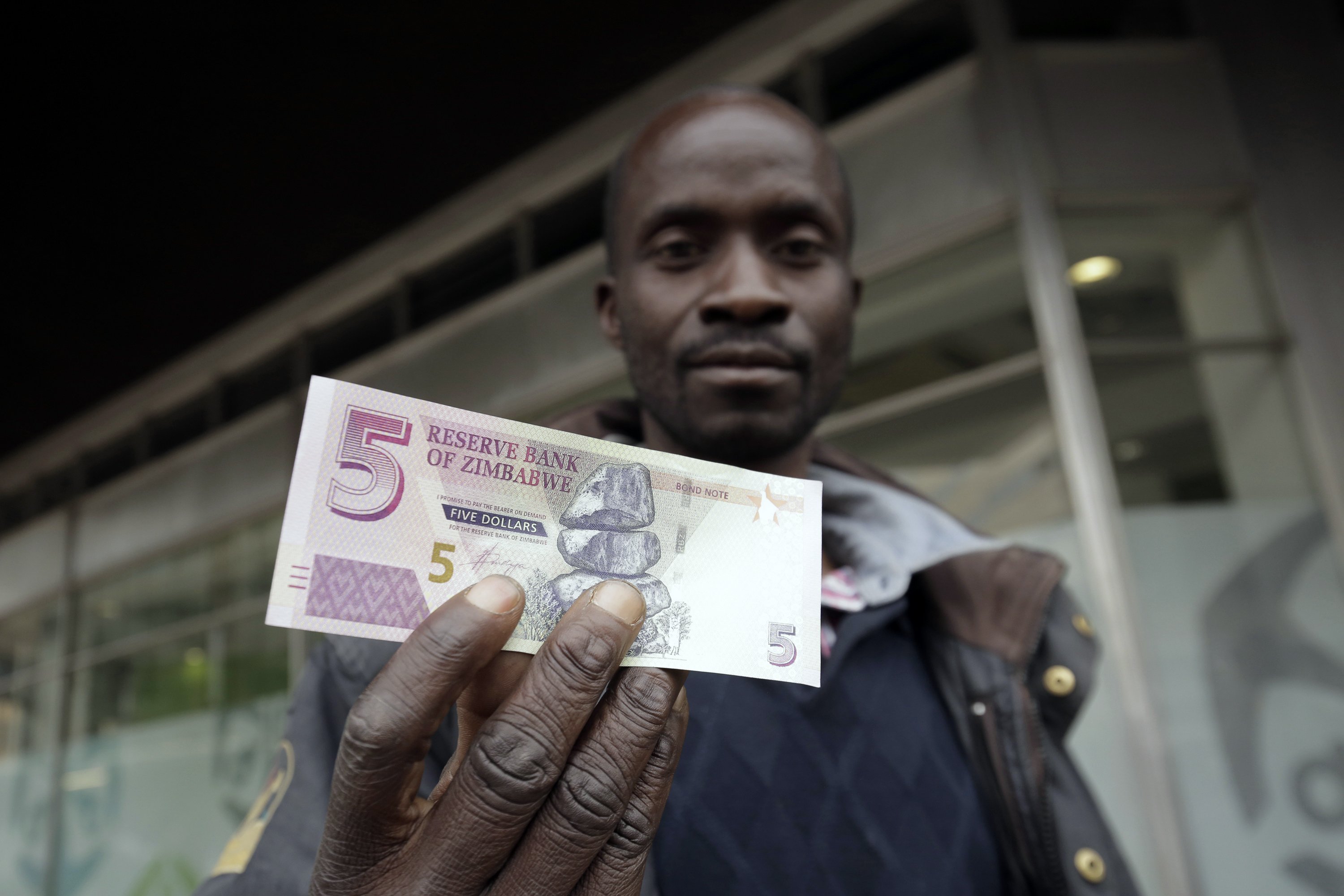 Zimbabwe president praises reintroduction of local currency AP News