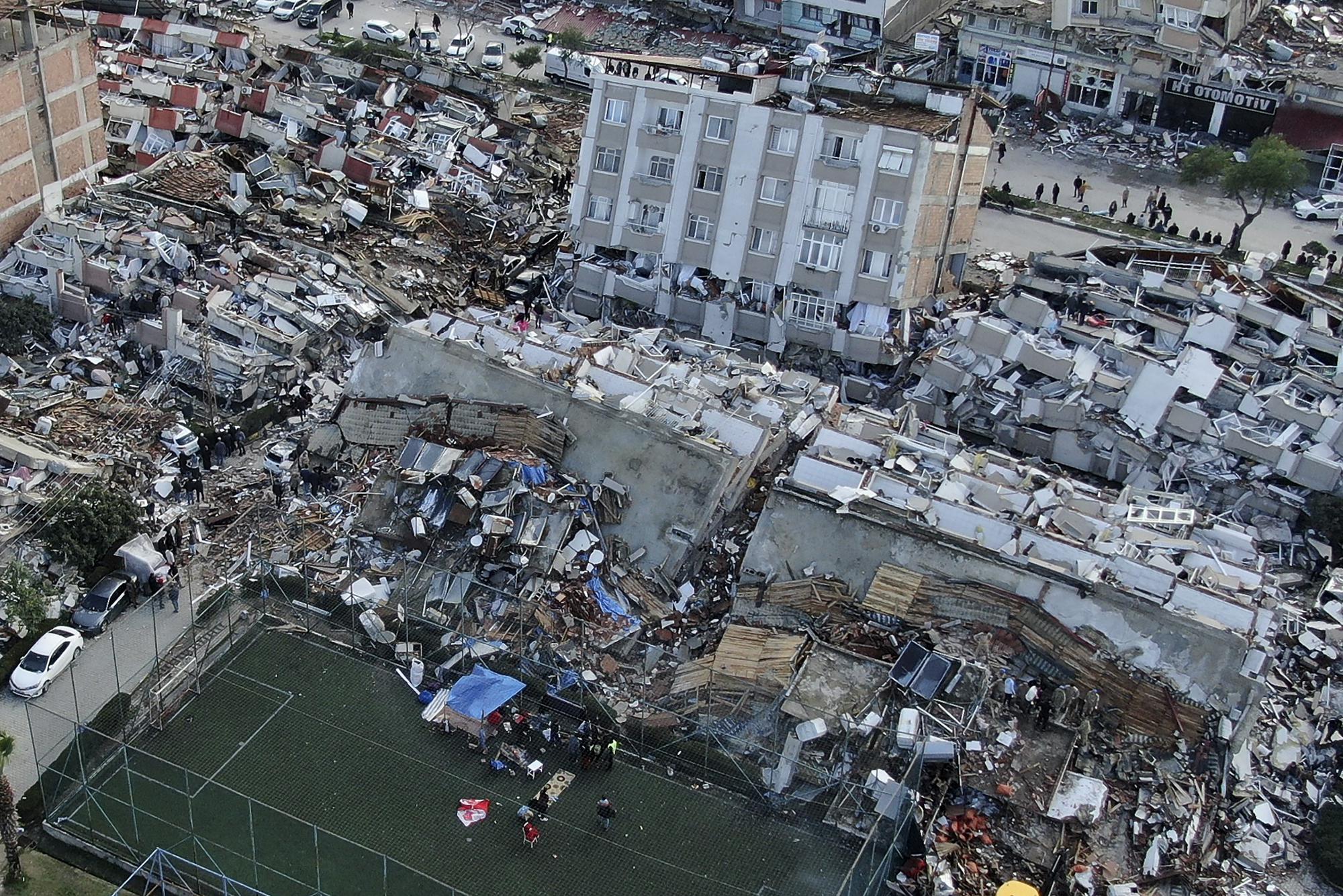 Aerial photo shows the destruction in Hatay city center, southern Turkey, Tuesday, Feb. 7, 2023. Search teams and emergency aid from around the world poured into Turkey and Syria on Tuesday as rescuers working in freezing temperatures dug — sometimes with their bare hands — through the remains of buildings flattened by a magnitude 7.8 earthquake. The death toll soared above 5,000 and was still expected to rise. of collapsed buildings across the region. (IHA via AP)