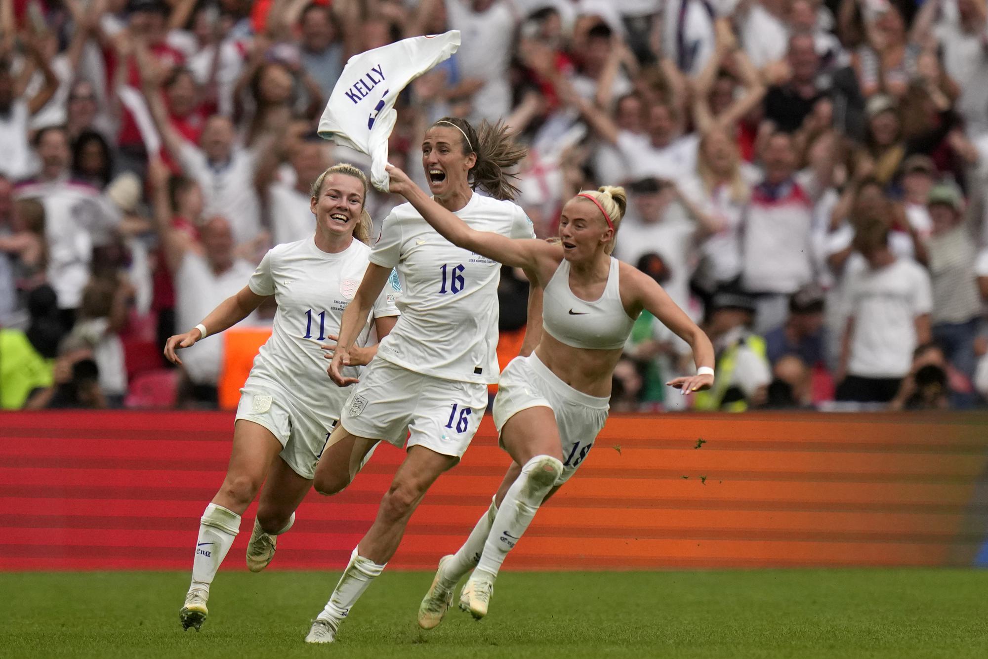 FILE - England's Chloe Kelly, right, celebrates after scoring her side's second goal during the Women's Euro 2022 final soccer match between England and Germany at Wembley stadium in London, Sunday, July 31, 2022. (AP Photo/Alessandra Tarantino, File)
