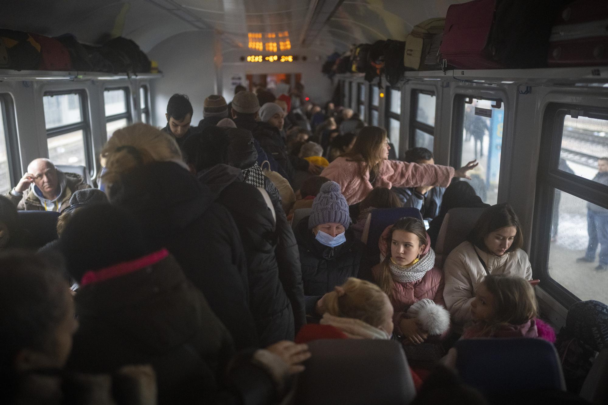 Women and children crowd a train bound for Lviv at the Kyiv station, Ukraine, Thursday, March 3. 2022. (AP Photo/Emilio Morenatti)