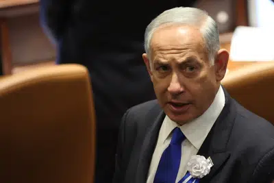 FILE - Israel's Likud Party leader Benjamin Netanyahu arrives during the swearing-in ceremony for Israeli lawmakers at the Knesset, Israel's parliament, in Jerusalem, Tuesday, Nov. 15, 2022. Netanyahu issued a rare rebuke of his new coalition allies on Sunday, Dec. 25, for saying they would advance laws allowing discrimination against LGBTQ people, pledging there would be no harm to their rights by his new government. (Abir Sultan/Pool Photo via AP, File)