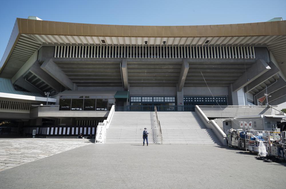 A police officer stands guard at the building to be used for the state funeral of former Prime Minister Shinzo Abe as authorities have deployed extra officers to beef up securities in Tokyo, Monday, Sept. 26, 2022. Japanese Prime Minister Fumio Kishida is hosting the controversial state-sponsored ceremony for the former leader Tuesday. (AP Photo/Hiro Komae)