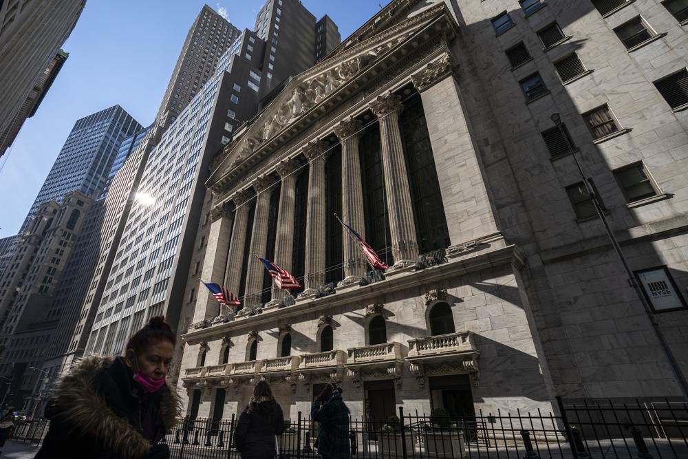 FILE - Pedestrians walk past the New York Stock Exchange, Monday, Jan. 24, 2022, in New York. The stock market's blockbuster gains in 2021 helped pad savers' retirement accounts, lifting the average balance on some popular investment plans to new highs. The average 401(k) plan balance stood at $130,700 at the end of last year, a 7.6% increase from 2020, according to a review of 20.4 million accounts by Fidelity Investments.  (AP Photo/John Minchillo, File)