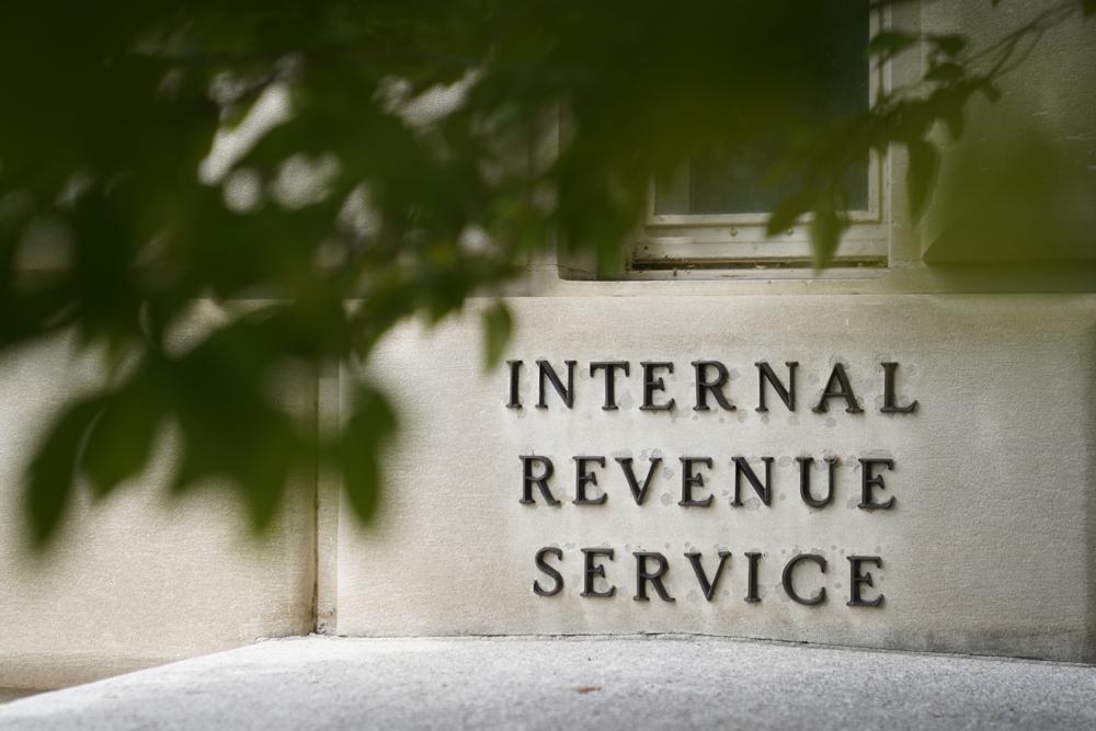 FILE - A sign is displayed outside the Internal Revenue Service building May 4, 2021, in Washington.A new government watchdog report finds that while most Americans are eligible to file their taxes for free, only a fraction use the services provided through the government. (AP Photo/Patrick Semansky, File)