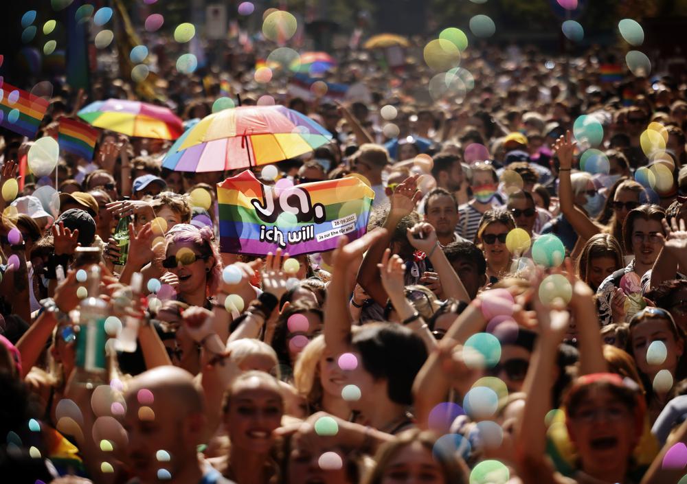 FILE - In this Saturday, Sept. 4, 2021 file photo, people take part in the Zurich Pride parade in Zurich, Switzerland, with the slogan "Dare. Marriage for all, now!" (Trau Dich. Ehe fuer alle. Jetzt!) for the rights of the LGBTIQ community. Swiss voters will wrap up a referendum on Sunday Sept. 26, 2021, to decide whether to allow same-sex marriage in the rich Alpine country, with supporters hoping for a big step toward ending discrimination against gays and lesbians while opponents fear what they consider an erosion of traditional family values. (Michael Buholzer/Keystone via AP, File)