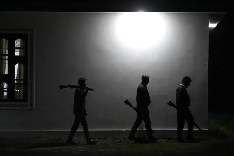 Village Defense Group members patrol during night at Muradpur village in Rajouri, India, Feb. 8, 2023. Days after seven Hindus were killed in the village in disputed Kashmir, hundreds of residents staged protests across the region's Hindu-dominated areas. In response, Indian authorities revived a government-sponsored militia and began rearming and training villagers. The militia, officially called the “Village Defense Group,” was initially formed in the 1990s as the first line of defense against anti-India insurgents in remote villages that government forces could not reach quickly. (AP Photo/Channi Anand)