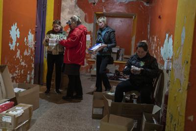 Volunteers store medicines at a Ukrainian volunteer center in Mykolaiv, southern Ukraine, on Monday, March 28, 2022. Ukrainian volunteers have set up a center to supply army and civilians with clothes, food, medicines and makeshift bullet proof vests. (AP Photo/Petros Giannakouris)