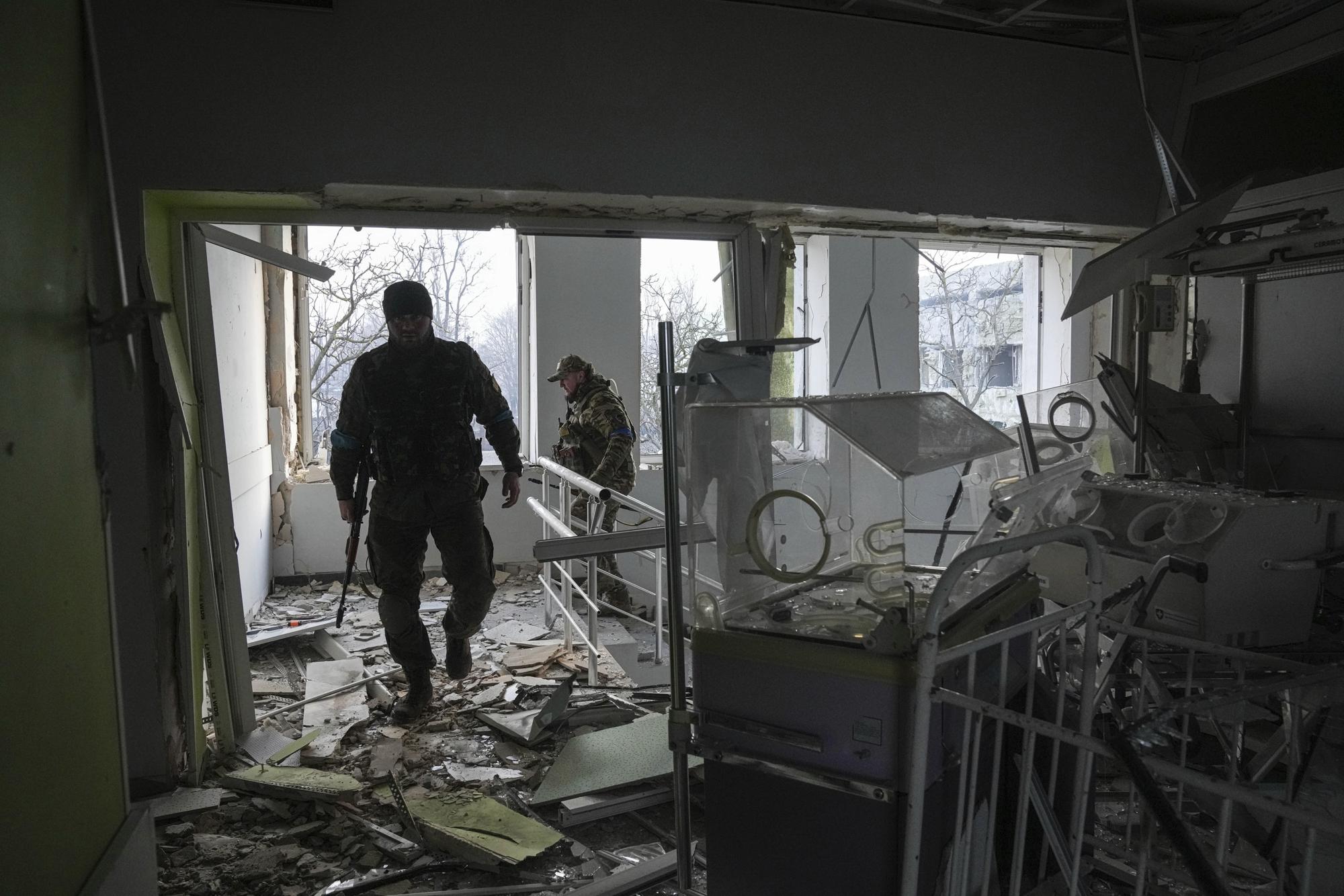 FILE - Ukrainian servicemen work inside of a maternity hospital that was damaged by shelling in Mariupol, Ukraine, March 9, 2022. (AP Photo/Evgeniy Maloletka, File)