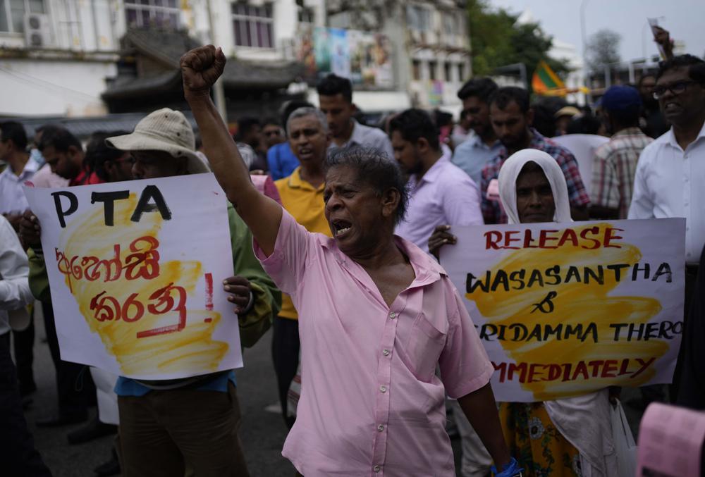 An anti government protester shouts slogans during a protest march in Colombo, Sri Lanka, Wednesday, Nov. 2, 2022. The protestors were demanding the release of two detained  protest leaders and to end the government’s crackdown on protests against an unprecedented economic crisis that has engulfed the island nation for months. (AP Photo/Eranga Jayawardena)