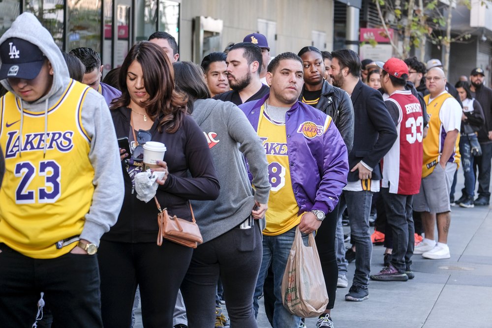 Fans line up to get into the Staples Center to attend a public memorial for former Los Angeles Lakers star Kobe Bryant and his daughter, Gianna, in Los Angeles, Monday, Feb. 24, 2020. (AP Photo/Ringo H.W. Chiu)