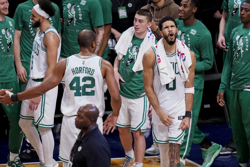 Boston Celtics forward Jayson Tatum (0) celebrates as his team holds the lead in the final seconds of the second half of Game 4 of an NBA basketball first-round playoff series against the Brooklyn Nets, Monday, April 25, 2022, in New York. (AP Photo/John Minchillo)