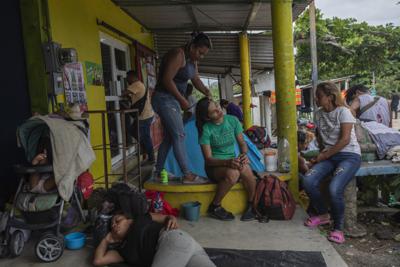 La migrante hondureña Yoselin peina a su amiga transgénero Ingrid Linares durante un descanso de la caravana de migrantes en Jesús Carranza, en el estado de Veracruz, México, el miércoles 17 de noviembre de 2021. (AP Foto / Félix Márquez)