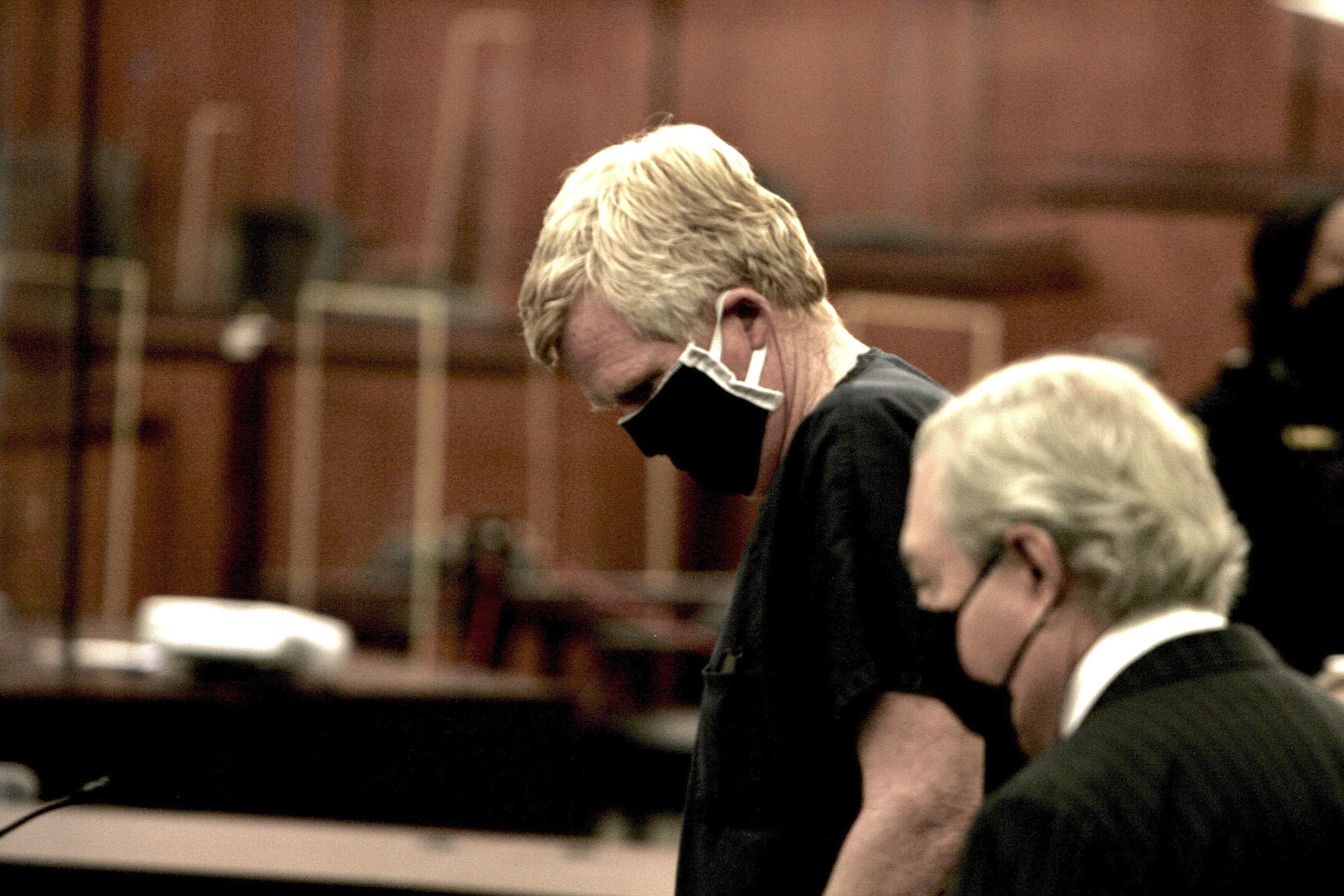 Buster Murdaugh holds his head in hands as his father sobs about