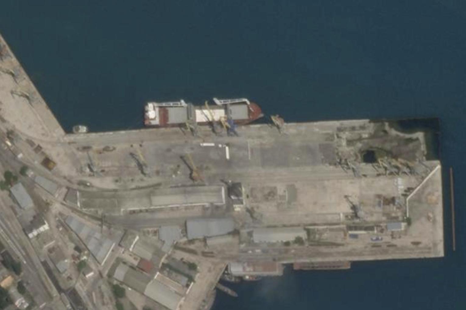 In this Planet Labs satellite image, the cargo ship Laodicea is docked at a port in Feodosia, Crimea, on July 11, 2022. Two weeks later, when it arrived at the Lebanese port city Tripoli, a manifest falsely claimed the barely and wheat flour in its hold was loaded at a small Russian port on the other side of the Black Sea. (Planet Labs via AP)