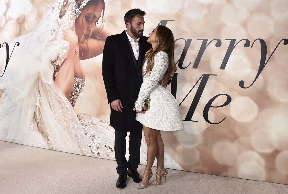 Cast member Jennifer Lopez, right, and Ben Affleck attend a photo call for a special screening of "Marry Me" at DGA Theater on Tuesday, Feb. 8, 2022, in Los Angeles. (Photo by Jordan Strauss/Invision/AP)