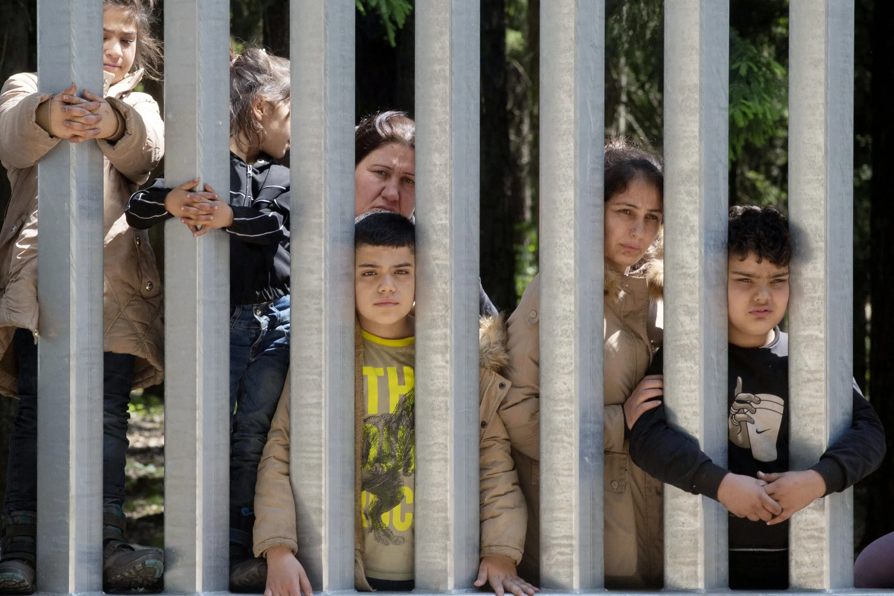 Migrants with children stuck at Poland’s border wall; activists say Belarus won’t let them turn back