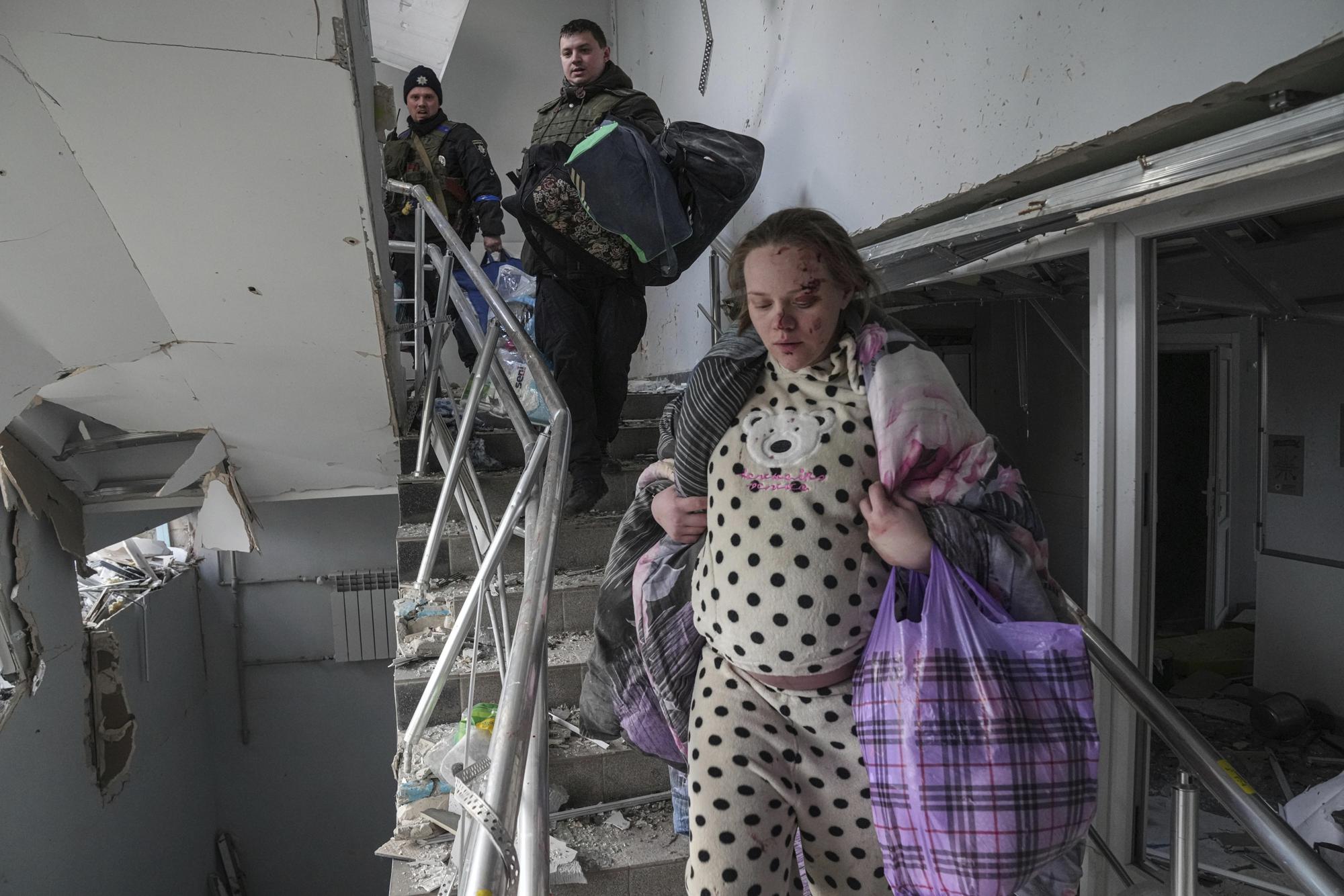 FILE - Mariana Vishegirskaya walks downstairs at a maternity hospital damaged by shelling in Mariupol, Ukraine, March 9, 2022. Vishegirskaya survived the shelling and later delivered a baby girl in another hospital. (AP Photo/Evgeniy Maloletka)