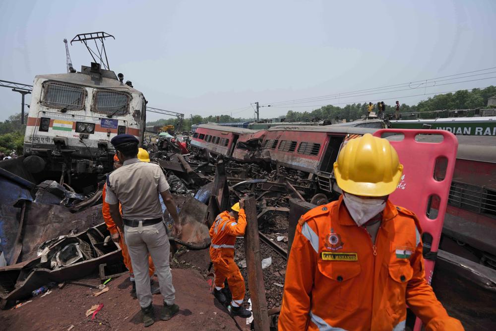 Rescuers work at the site of passenger trains that derailed in Balasore district, in the eastern Indian state of Orissa, Saturday, June 3, 2023. Rescuers are wading through piles of debris and wreckage to pull out bodies and free people after two passenger trains derailed in India, killing more than 280 people and injuring hundreds as rail cars were flipped over and mangled in one of the country’s deadliest train crashes in decades. (AP Photo/Rafiq Maqbool)