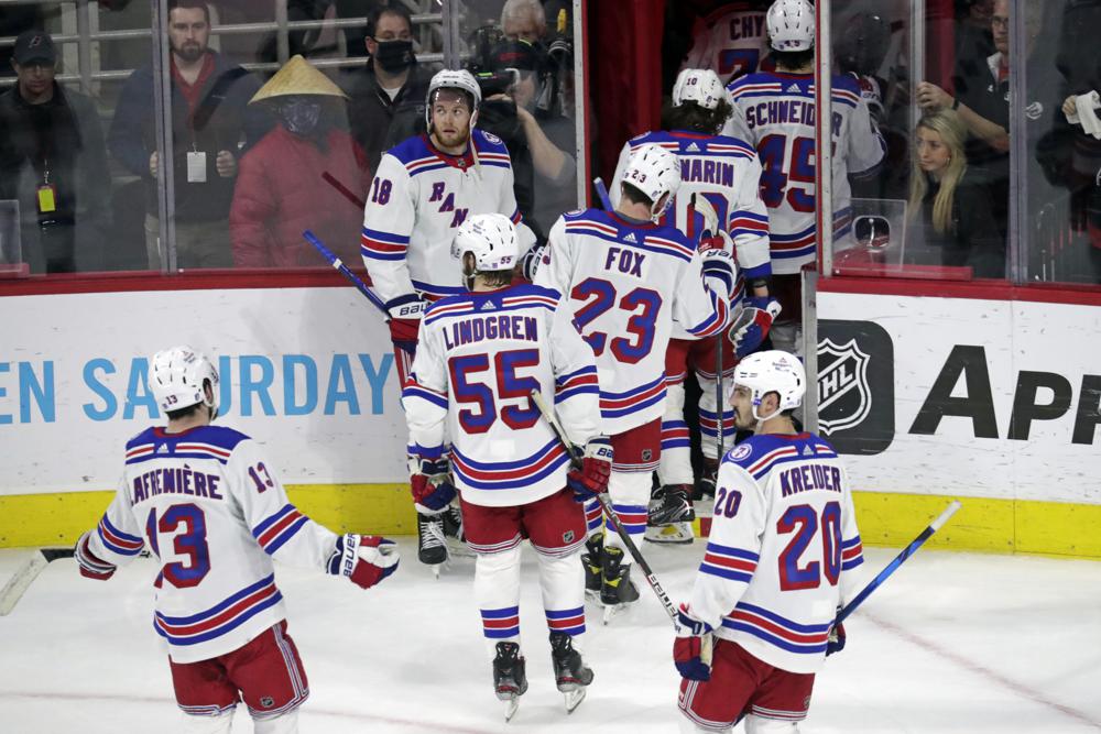 The New York Rangers skate off the ice after losing 3-1 to the Carolina Hurricanes in Game 5 of an NHL hockey Stanley Cup second-round playoff series Thursday, May 26, 2022, in Raleigh, N.C. (AP Photo/Chris Seward)