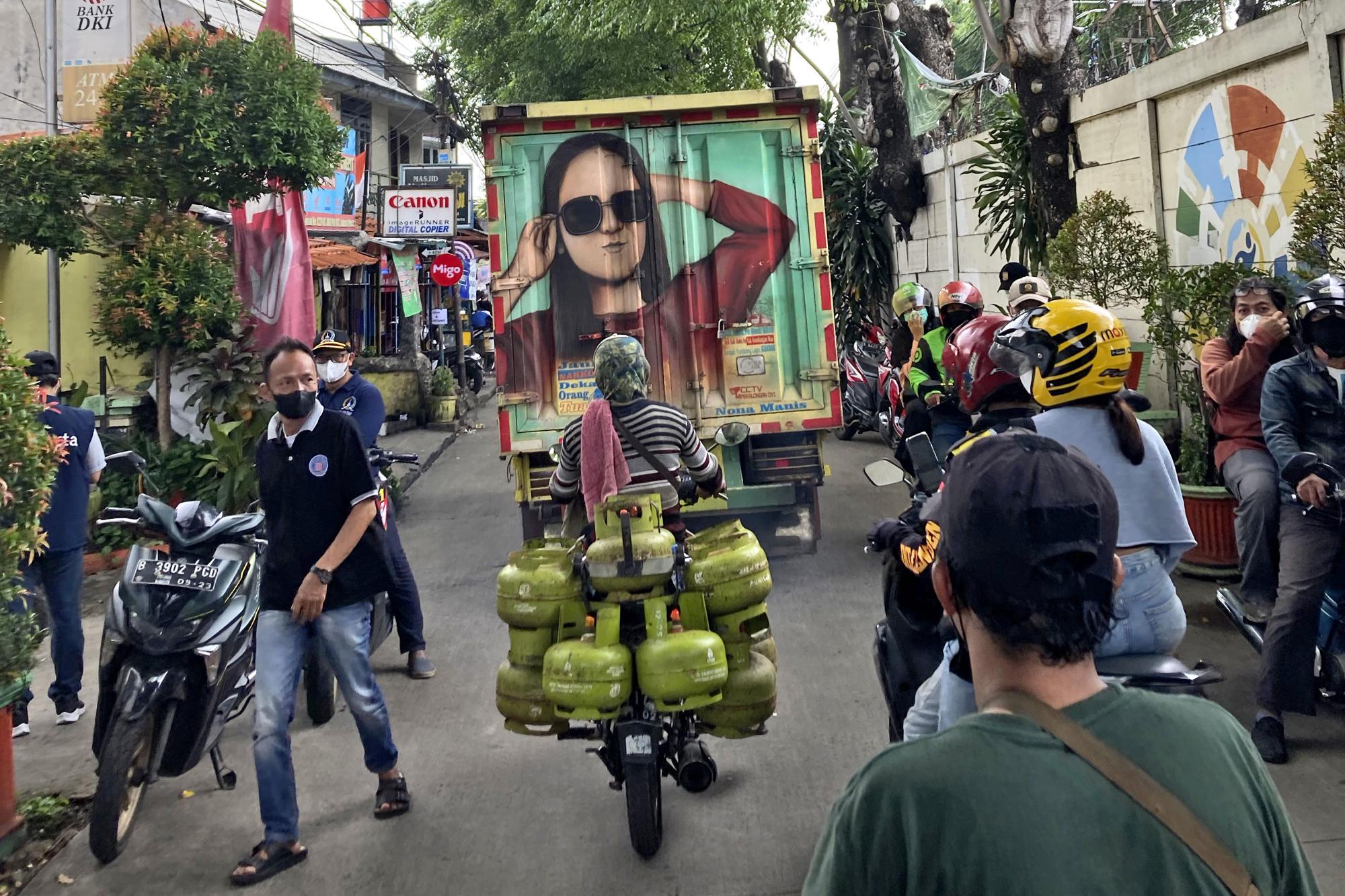 People make their way through a crowded street in Jakarta, Indonesia, in this Saturday, Feb 5, 2022 iPhone photo. "People are so used to see others taking photos with their gadgets that they just ignore me. This gives me a whole new perspective to explore and easily get me to the nooks and crannies of a city of 10 million people — a place where a "real camera" would feel awkward to operate," wrote Alangkara. (AP Photo/Dita Alangkara)