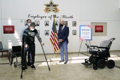 El presidente Joe Biden observa cómo el veterano John Caruso camina con la ayuda de un exoesqueleto y es asistido por Joshua Geering, terapeuta principal de terapia SCI, Centro de Lesiones / Discapacidades de la Médula Espinal en Dallas, mientras Biden recorre la Clínica va de Fort Worth en Fort Worth, Texas, el martes 8 de marzo de 2022. (AP Photo/Patrick Semansky)