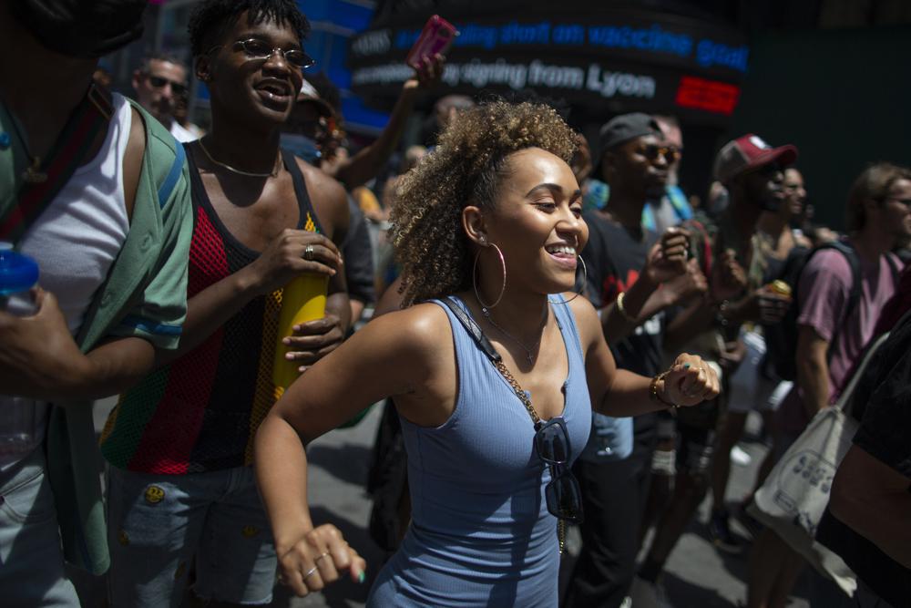 People attend a free outdoor event organized by The Broadway League during Juneteenth celebrations at Times Square on Saturday, June 19, 2021, in New York. Parades, picnics and lessons in history marked Juneteenth celebrations in the U.S., a day that marks the arrival of news to enslaved Black people in a Texas town that the Confederacy had surrendered in 1865 and they were free. (AP Photo/Eduardo Munoz Alvarez)