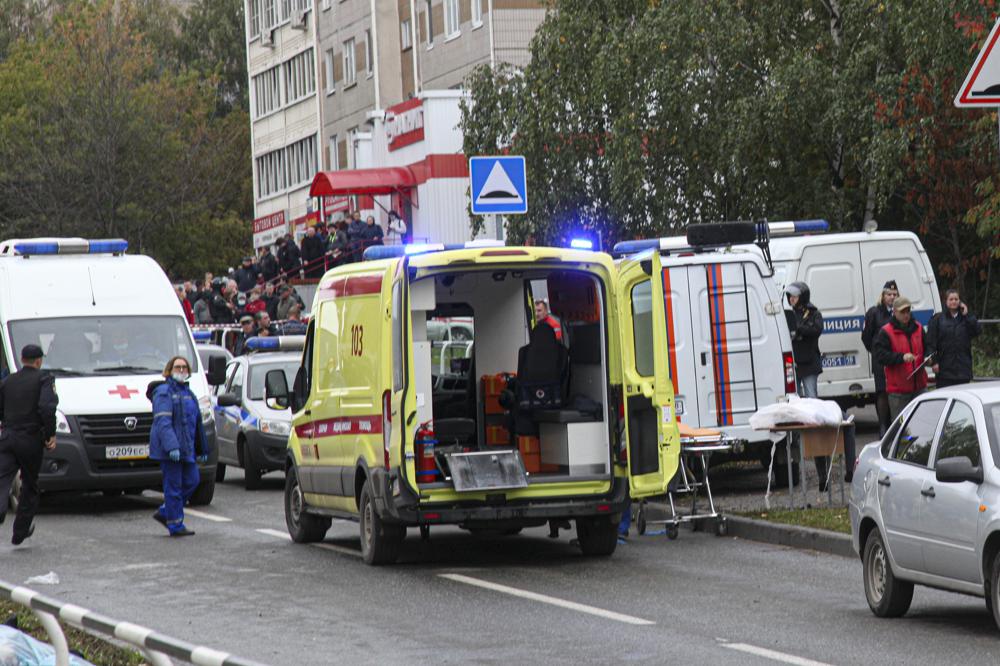 Police and paramedics work at the scene of a shooting at school No. 88 in Izhevsk, Russia, Monday, Sept. 26, 2022. A gunman on Monday morning killed 13 people and wounded 21 others in a school in central Russia, authorities said. Russia's Investigative Committee said in statement that seven children were among those killed in the shooting in the school in Izhevsk, a city about 960 kilometers (596 miles) east of Moscow in the Udmurtia region. (AP Photo)