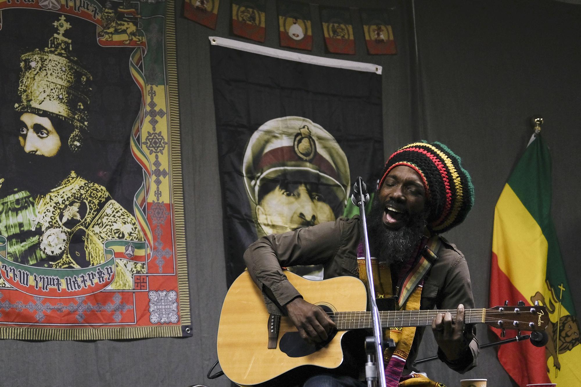 Mark Hunter, lead singer of the Ark Band, performs at an event organized by the nonprofit Rastafari Coalition marking the 91st anniversary of the coronation of the late Ethiopian Emperor Haile Selassie I on Tuesday, Nov. 2, 2021, in Columbus, Ohio. The coronation day event also included chanting, traditional nyabinghi drumming and the reading of psalms, which are the core of Rastafari holiday celebrations. (AP Photo/Luis Andres Henao)