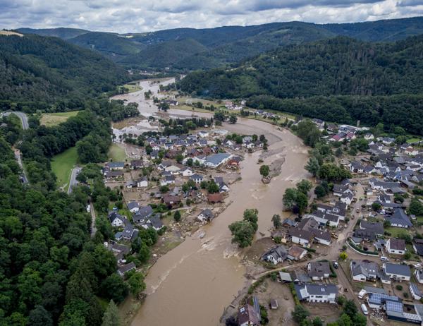 The Ahr river floats past destroyed houses in Insul, Germany, Thursday, July 15, 2021. Due to heavy rain falls the Ahr river dramatically went over the banks the evening before. (AP Photo/Michael Probst)