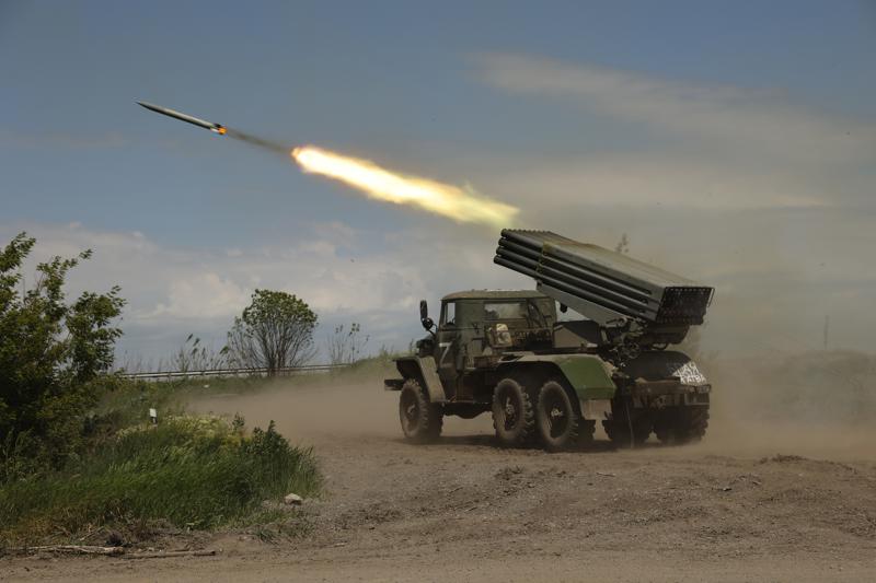 FILE - A Donetsk People's Republic militia's multiple rocket launcher fires from its position not far from Panteleimonivka, in territory under the government of the Donetsk People's Republic, eastern Ukraine, Saturday, May 28, 2022. Day after day, Russia is pounding the Donbas region of Ukraine with relentless artillery and air raids, making slow but steady progress to seize the industrial heartland of its neighbor. With the conflict now in its fourth month, it’s a high-stakes campaign that could dictate the course of the entire war. (AP Photo/Alexei Alexandrov, file)