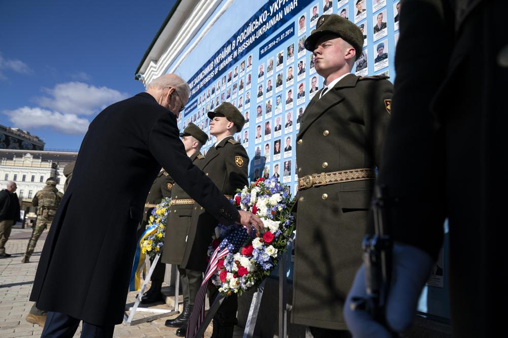 US President Joe Biden participates in a wreath laying ceremony with Ukrainian President Volodymyr Zelenskyy at the memorial wall outside of St. Michael's Golden-Domed Cathedral during an unannounced visit, in Kyiv, Ukraine, Monday, Feb. 20, 2023. (AP Photo/Evan Vucci)