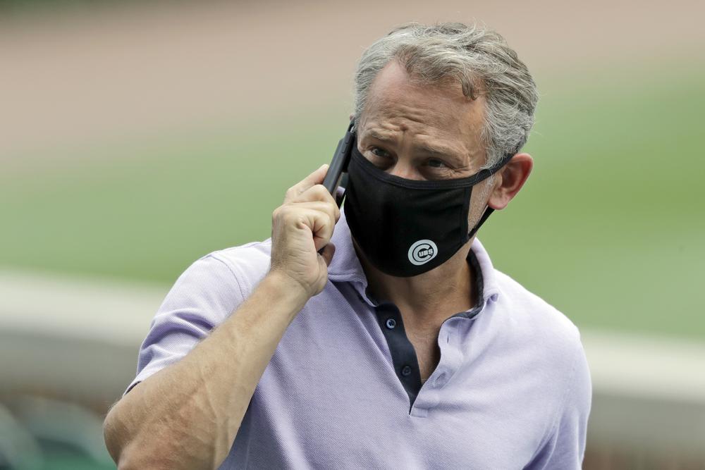 FILE - In this July 8, 2020, file photo, Chicago Cubs general manager Jed Hoyer talks on a mobile phone during the team's baseball practice at Wrigley Field in Chicago. Chicago Cubs manager David Ross and president of baseball operations Jed Hoyer have tested positive for COVID-19. (AP Photo/Nam Y. Huh, File)